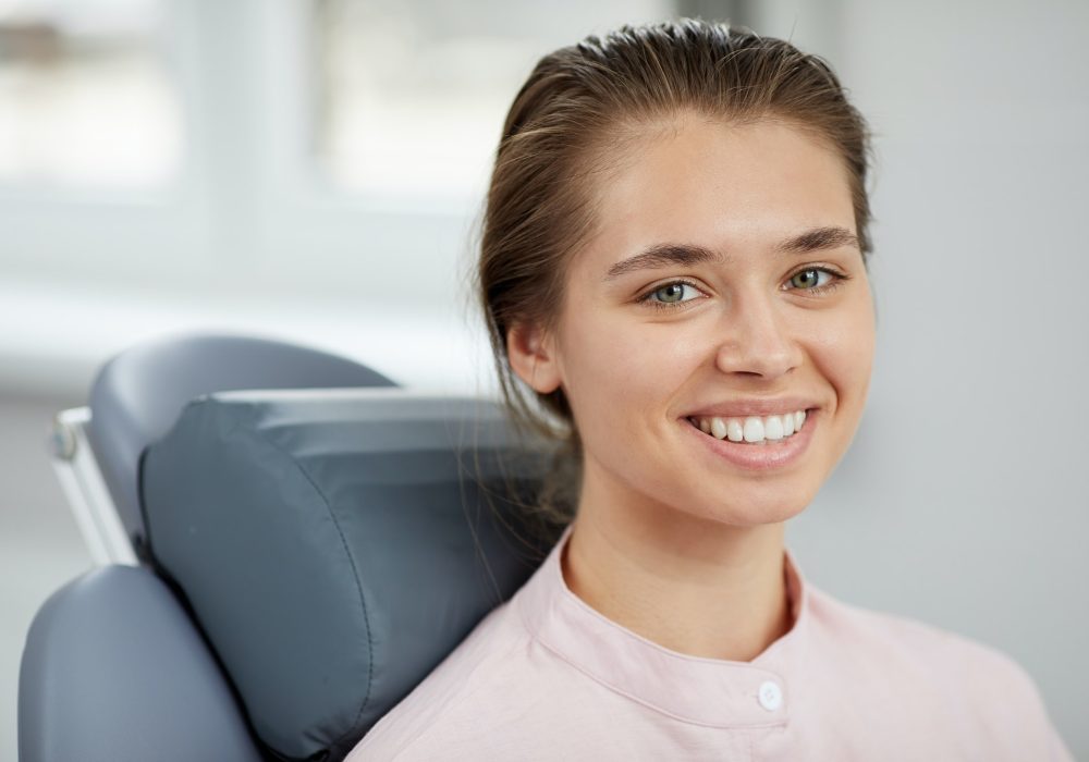 Smiling Young Woman in Dental Chair
